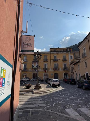 a building with a sign on the side of a street at B&B Popoli Terme in Popoli