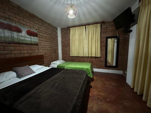 Postel nebo postele na pokoji v ubytování La Fogata del Sur