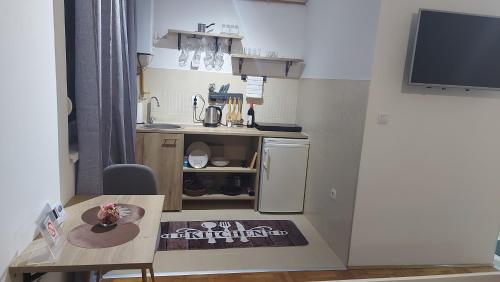 a small kitchen with a small table and a small kitchen at River stay in Sremska Mitrovica
