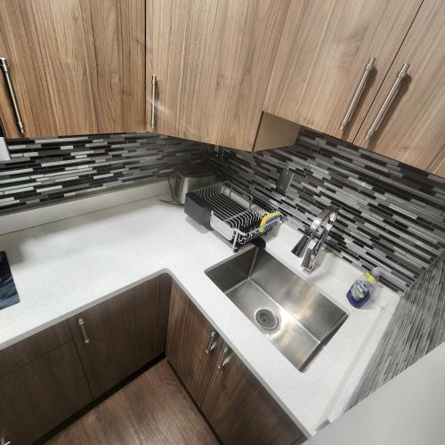 a kitchen with a sink and wooden cabinets at beautiful private house in Edmonton
