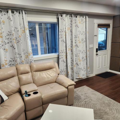 a living room with a couch and a window at beautiful private house in Edmonton