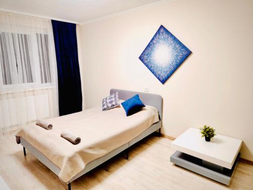 a bedroom with a bed and a table at M&M Apartment V SELF CHECK-IN in Panevėžys
