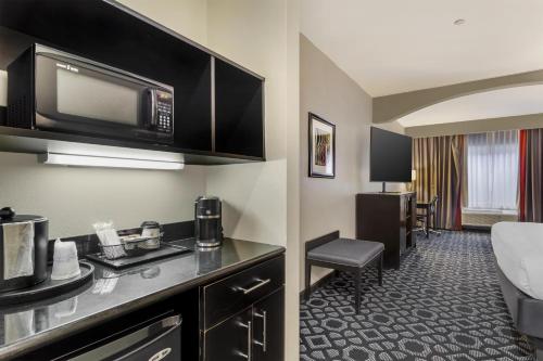 a hotel room with a kitchen with a microwave at Best Western Plus Laredo Inn & Suites in Laredo
