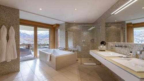 a bathroom with two sinks and a tub and a shower at Entrebin PremiumChalet AO in Aosta