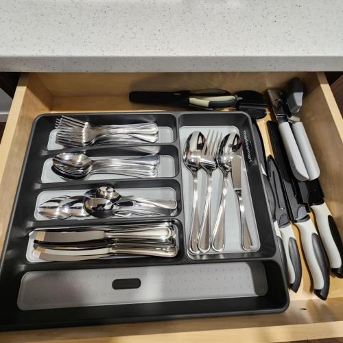 a drawer filled with silver utensils in a kitchen at beautiful private house in Edmonton