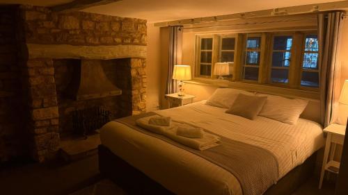 a bedroom with a bed with two towels on it at The Red lion in Gloucestershire