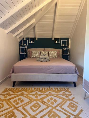 a bedroom with a bed with a purple bedspread at Villa AGADA GUEST HOUSE ONLY ADULT in Vieux-Fort