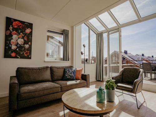 a living room with a couch and a table at Apartment in Waterpark in Uitgeest in Uitgeest