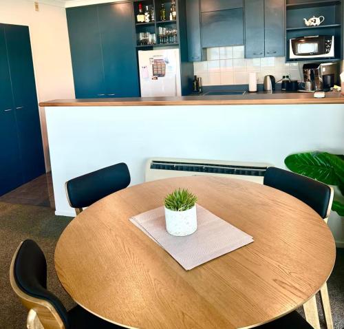 a wooden table with a potted plant on it in a kitchen at Stunning Lake Views in Queenstown