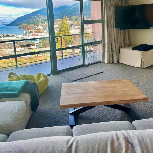 a living room with a couch and a coffee table at Stunning Lake Views in Queenstown