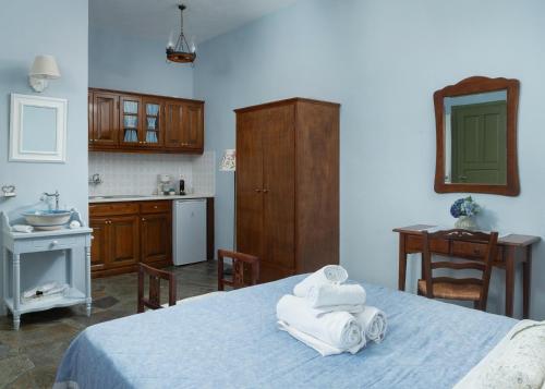 a bedroom with a bed with towels on it at Saint Louis in Andros