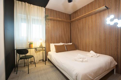 a bedroom with a bed and a desk and a window at Porto Panorama by Sira Stays in Porto