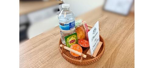 a bottle of water sitting on top of a table at Studio cosy tout équipé, idéal in Chilly-Mazarin