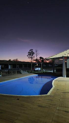 a large blue swimming pool next to a building at Carolina Palace HOTEL in Carolina