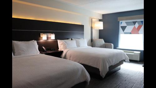 a hotel room with two beds and a window at Holiday Inn Express Brampton by IHG in Brampton