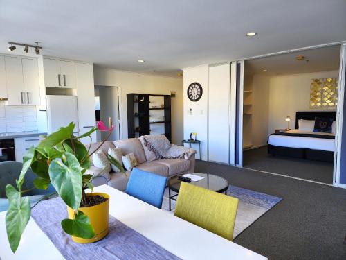 a living room with a couch and a table with chairs at U Residence Hotel, Signature Collection by BW in Wellington