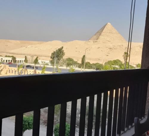 a view of the pyramids from a balcony at Pyramids & Grand Museum Apartment in Giza