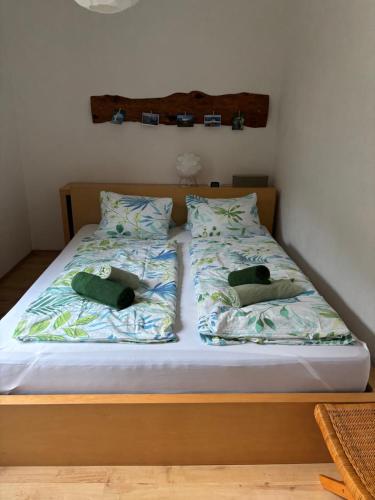 a bed with two pillows on top of it at Ferienwohnung Held in Obertraun
