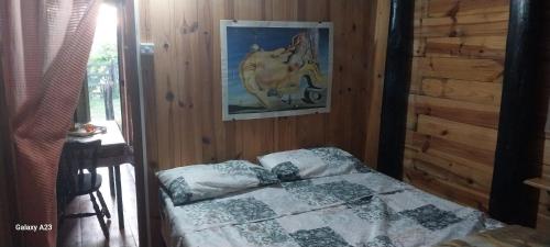 a bedroom with a bed with a picture of a horse on the wall at Recanto do pepe in Chuí