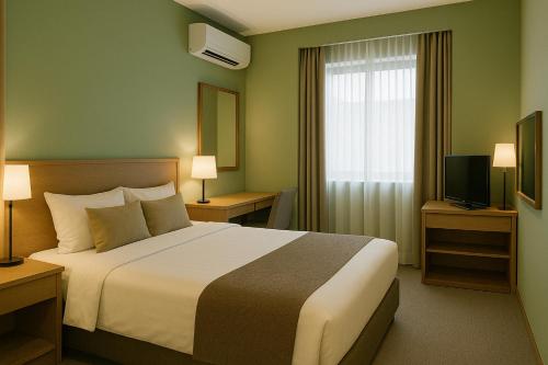 a hotel room with a bed and a window at The Grand Sanken Hotel in Kalodran