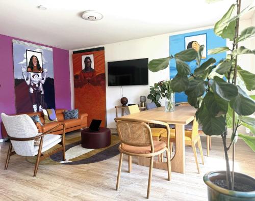 a living room with a table and chairs at uta house la plaine in Saint-Denis