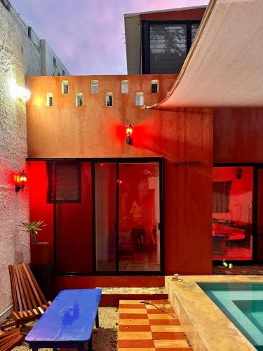 a house with a blue table and a swimming pool at Casa Arcana Boutique in Mérida