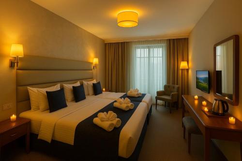 a hotel room with a large bed with two towels at Istanbul Midpoint Hotel in Istanbul