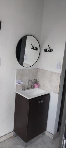 a bathroom with a sink and a mirror on the wall at Quincho Gala in El Cadillal
