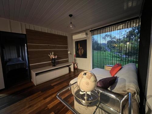 a room with a bed and a table and a window at Pool amid the green in Gaspar