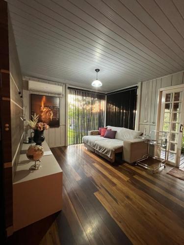 a large living room with a bed and a table at Pool amid the green in Gaspar