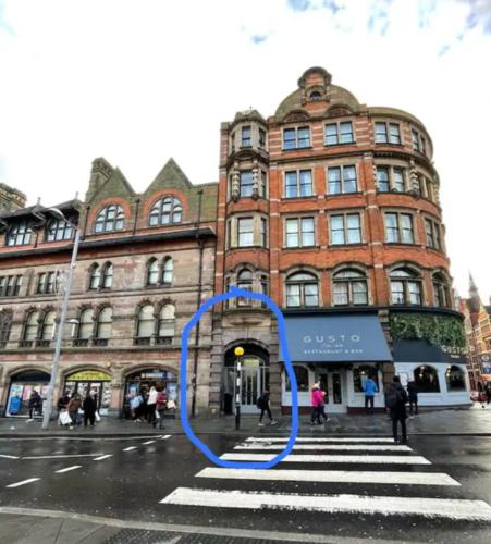 a blue circle on a street in front of a building at Modern Studio, Top Floor, King Street Views in Nottingham