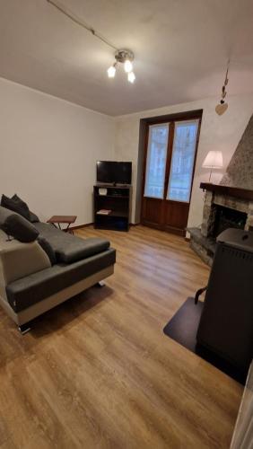 a living room with a couch and a fireplace at Il Bucaneve in Mollia