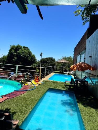a large swimming pool with a water park at Los Monges Aparthotel in Ciudad del Este