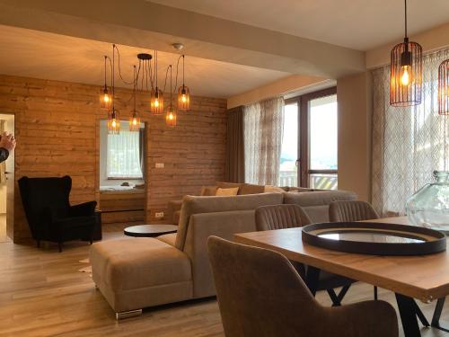 a living room with a couch and a table at Apartments Panorama Donovaly in Donovaly