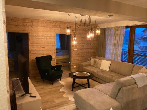 a living room with a couch and a television at Apartments Panorama Donovaly in Donovaly