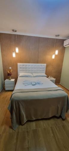 a bedroom with a large bed in a room at Pousada Emcanto in Vila Muriqui