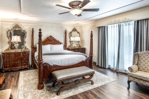 a bedroom with a bed and a chair and a fan at Fulton Steamboat Inn in Lancaster