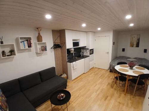 a living room with a couch and a table at Cozy Cottage Near the Skjern River in Tarm