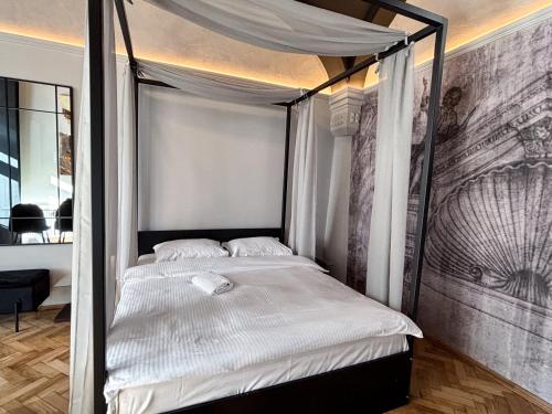 a bed with a canopy in a room at Moonlight City Center Studio Private Parking in Cluj-Napoca