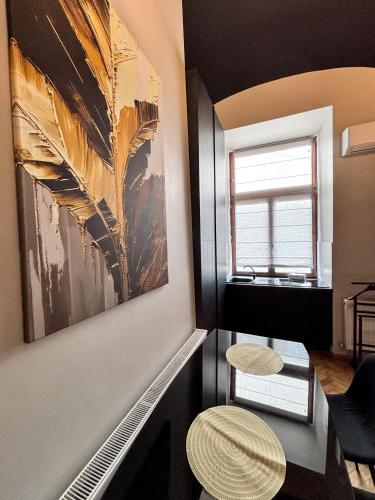 a room with a painting on the wall and two stools at Moonlight City Center Studio-Private Parking, king in Cluj-Napoca