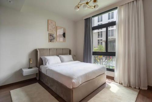 a bedroom with a bed and a large window at Luxury Apartments in Cairo Festival City in Cairo