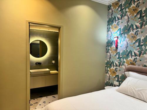a bedroom with a bed and a mirror and a sink at 603 Apartments in Baddah
