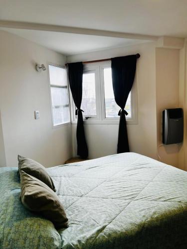 a bedroom with a large bed and a window at Downtown rental in Río Grande