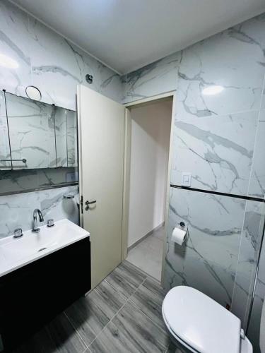 a bathroom with a sink and a toilet at Downtown rental in Río Grande