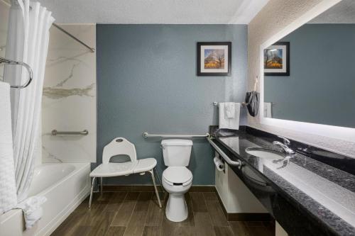 a bathroom with a toilet and a sink and a tub at Best Western Waldo Inn & Suites in Waldo