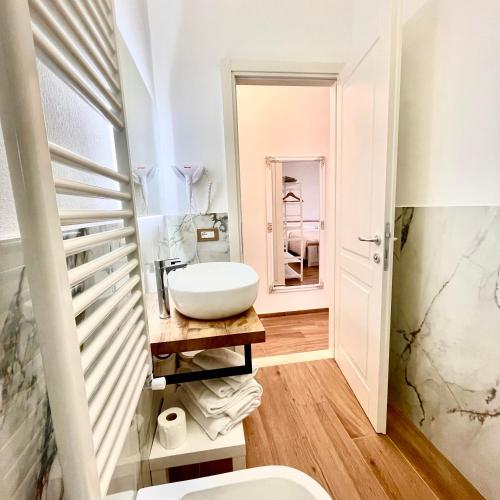 a bathroom with a sink and a mirror at Monte Boutique ROOMS in Montepulciano
