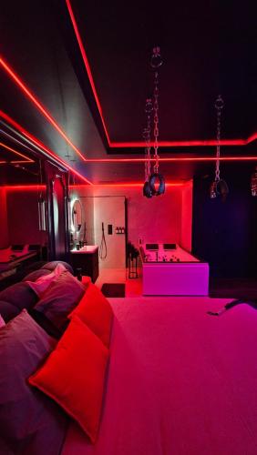 een kamer met een bed met rode verlichting bij Love room - Xtase By luxuria Cannes in Cannes