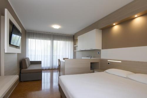 a hotel room with a bed and a chair at Residence all'Adige in Verona