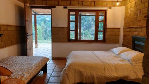 Postel nebo postele na pokoji v ubytování Casa Campestre a Estrenar Ráquira