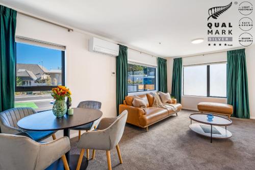 a living room with a couch and a table at Luxe Suites & Apartments in Queenstown